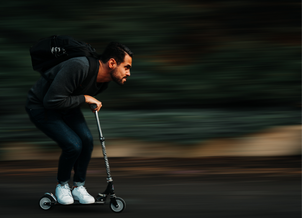 Man scootering at high speed.