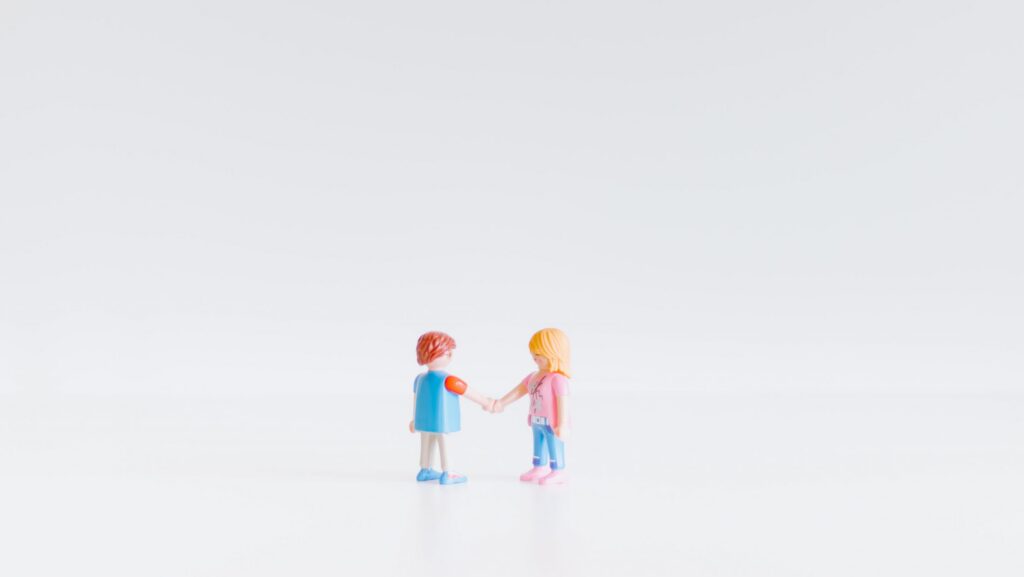 Small toys shaking hands.