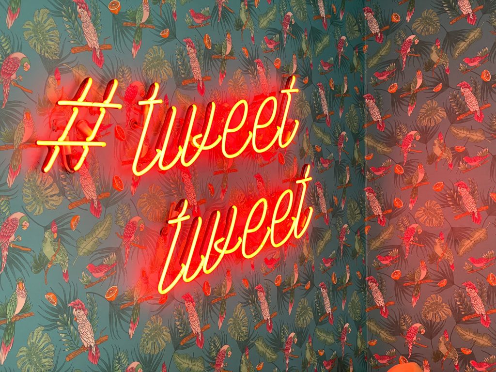 Neon sign that says #tweettweet