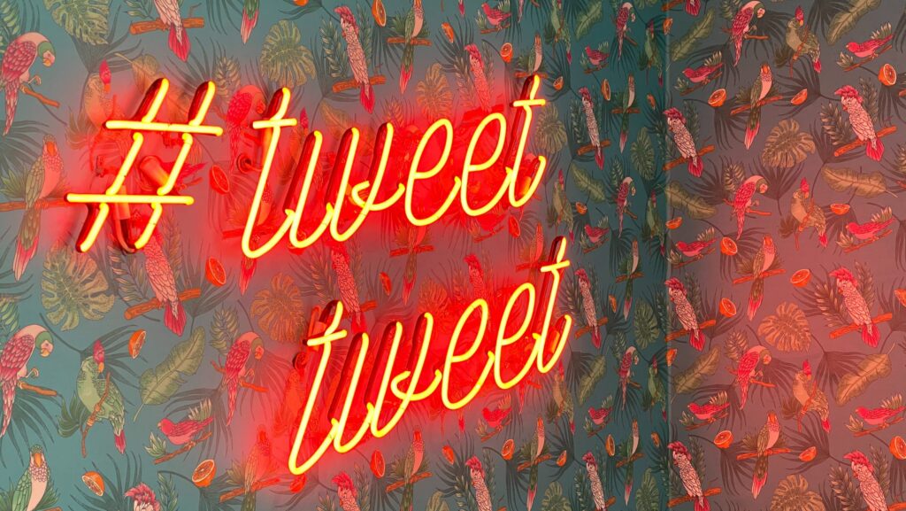 Neon sign that says #tweettweet