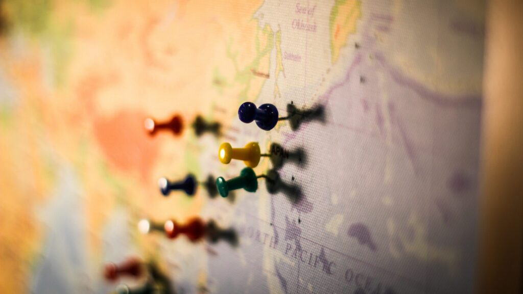 Map on wall with pushpins.