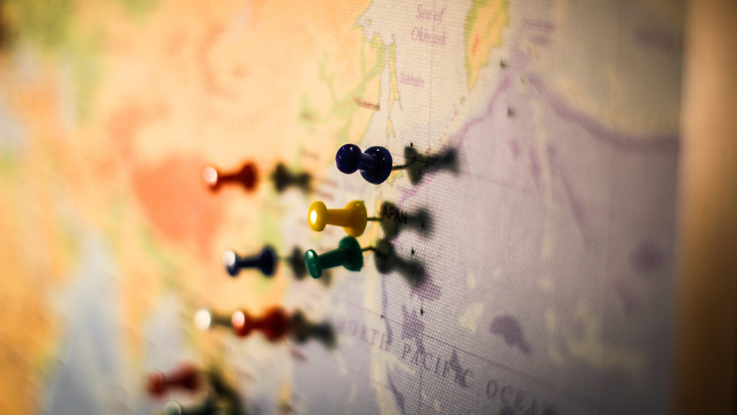 Map on wall with pushpins.