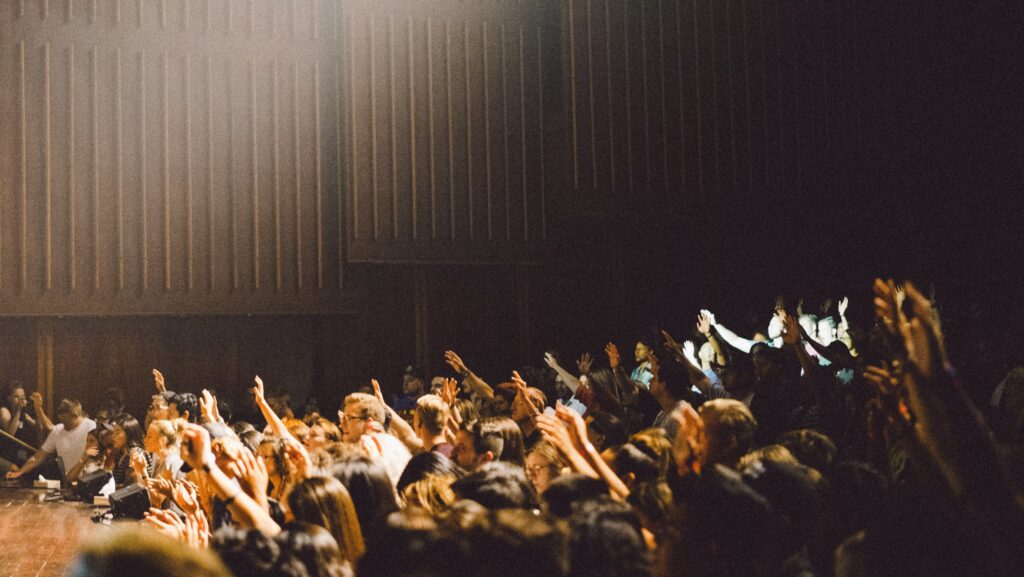 Crowd with raised hands.
