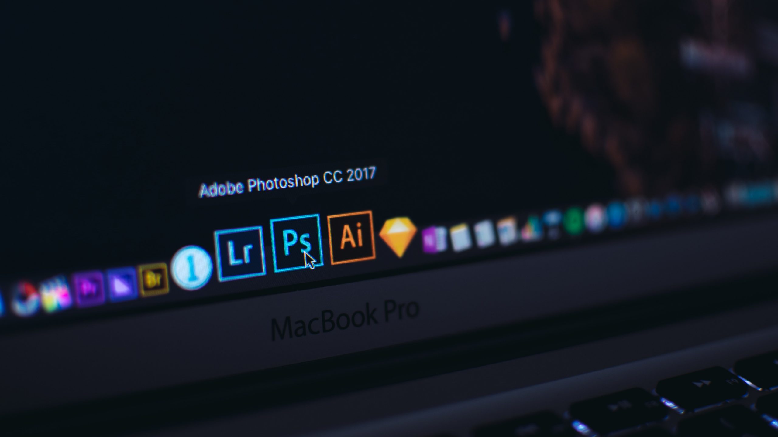 Photoshop icons on a laptop.
