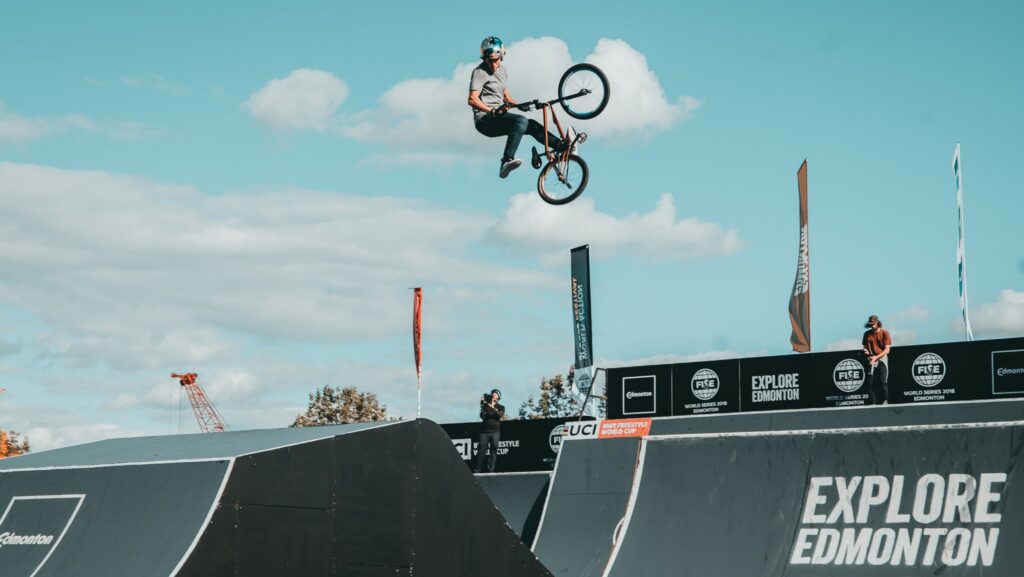 Bike riding above ramp.
